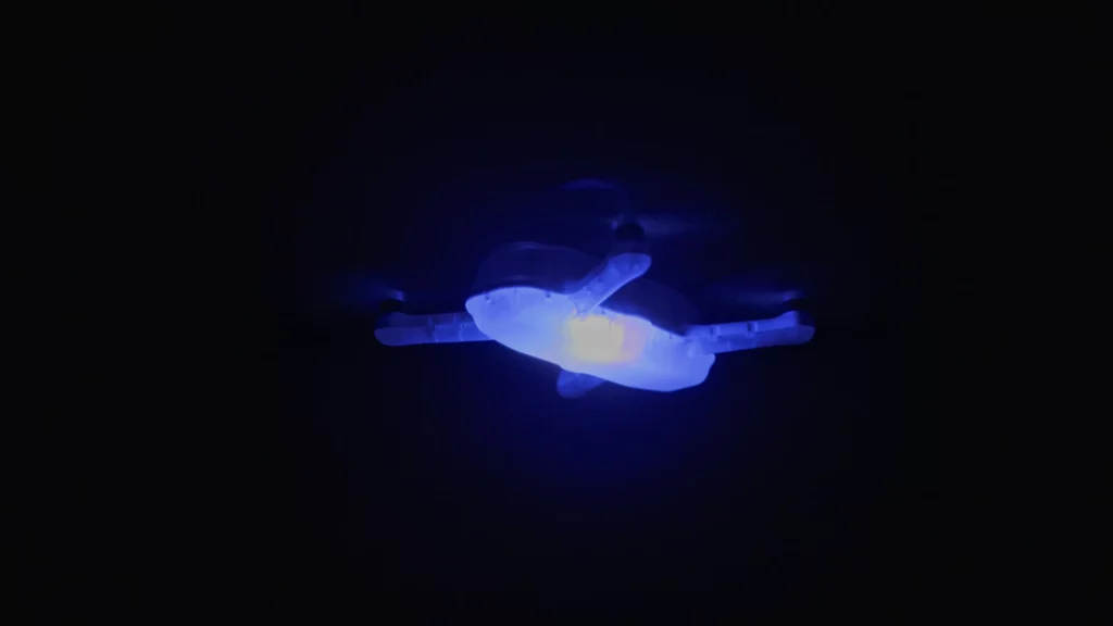 Professional drone with LED lighting flying at night, optimized for drone light shows and aerial performances.